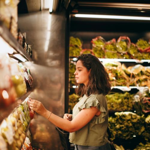 Consumer shopping in grocery store representing retail and trade strategy